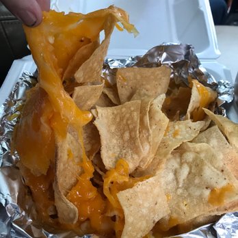 Burrito Boy - a hand picking up some tortilla chips - Mexican Near Me - Eugene, Oregon