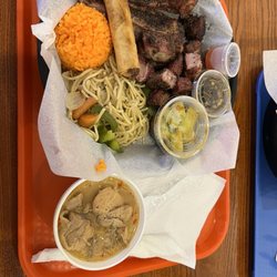 Hafa Adai Fiesta Food - Lunch Plate 3 Choice with pork ribs, smoked pork pieces, and spicy chicken. Also rice, lumpia, noodles, and cucumber salad.