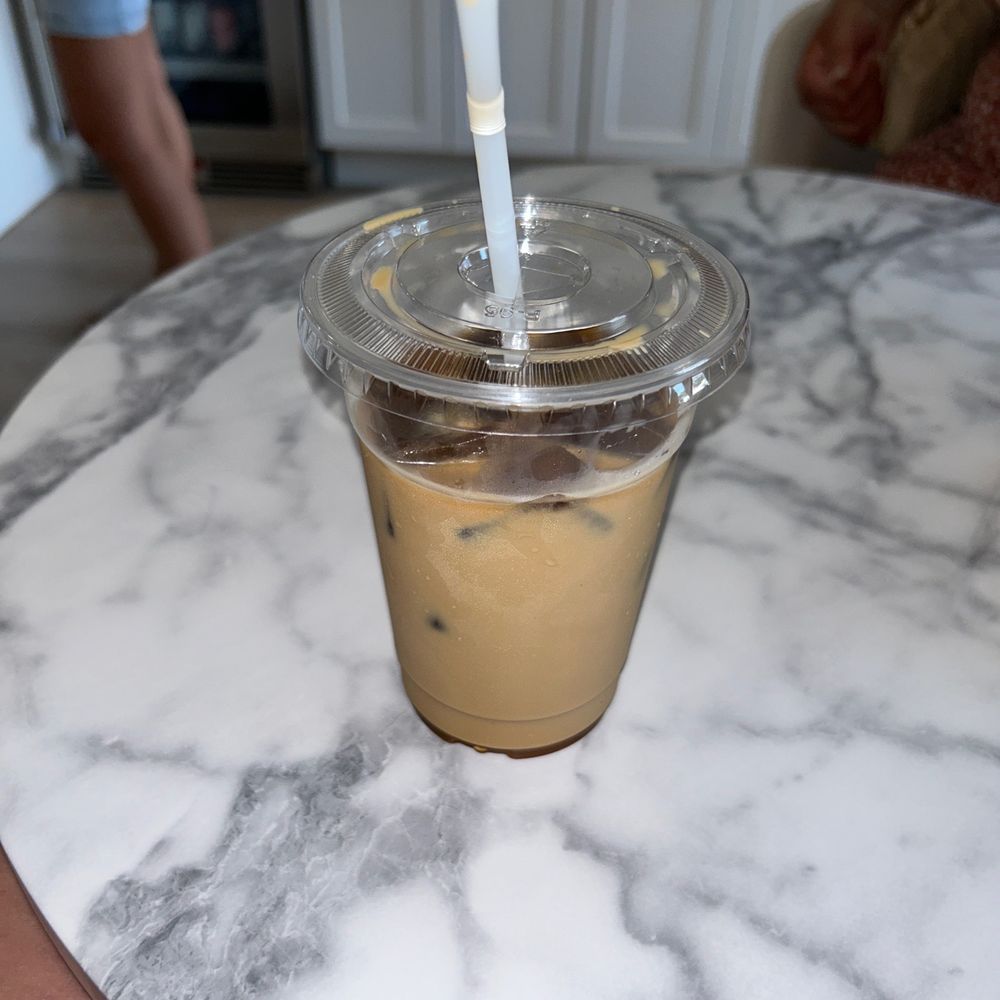 a cup of iced coffee on a marble table a cup of iced coffee on a marble table