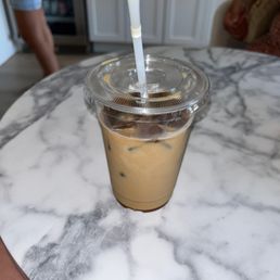 a cup of iced coffee on a marble table a cup of iced coffee on a marble table