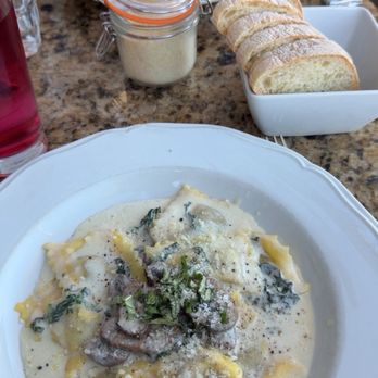 Paluca Trattoria - Short rib ravioli in the front, bread and Parmesan cheese and the Sicilian meatballs in the back. - Italian Near Me - Monterey, California