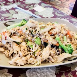a plate of fried rice and vegetables