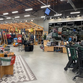 REI - The image shows the inside of an REI store in Burbank, CA, featuring outdoor clothing, backpacks, and gear displays, with shopping carts nearby. - Outdoor Gear Near Me - Burbank, California