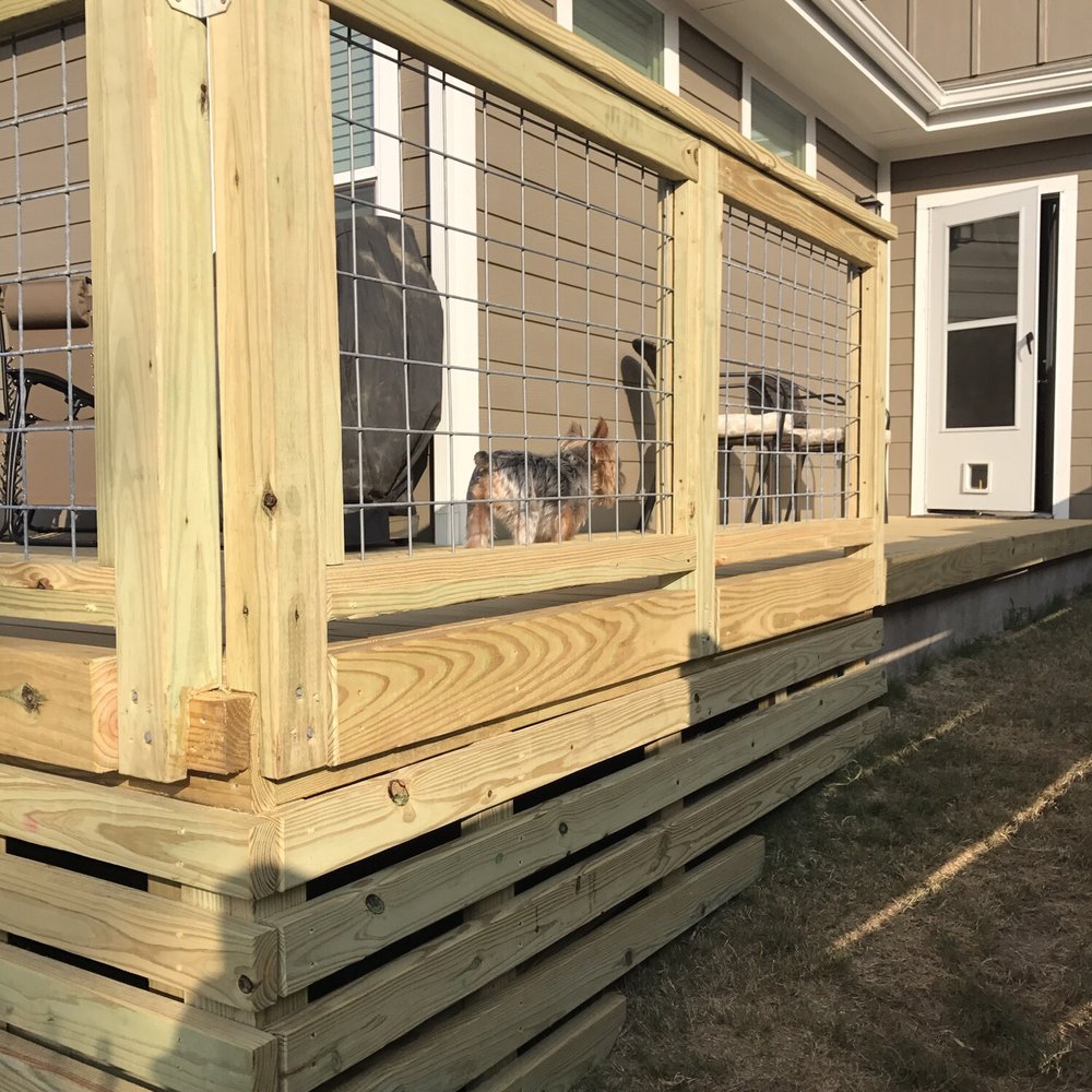 a dog in a cage on a deck a dog in a cage on a deck