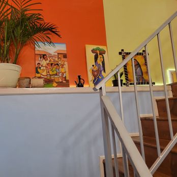 Buna Cafe Philly - a staircase with a potted plant - Ethiopian Near Me - Philadelphia, Pennsylvania Buna Cafe Philly - a staircase with a potted plant - Ethiopian Near Me - Philadelphia, Pennsylvania