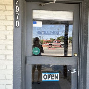 The Mail Drop - Front door with hours posted. - Shipping Centers Near Me - Georgetown, Texas