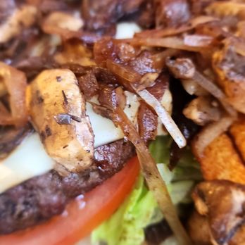 Chuck’s Bar and Grill - Close up of the Mushroom Cheeseburger with fresh fries. - Burgers Near Me - Bulverde, Texas Chuck’s Bar and Grill - Close up of the Mushroom Cheeseburger with fresh fries. - Burgers Near Me - Bulverde, Texas