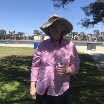 Mother's Beach - Susan in the shade on the grass behind her is the water - Parks Near Me - Long Beach, California