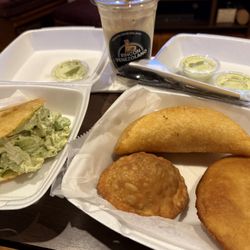 Rincón Venezolano - Reina Pepiada on the left, Two empanadas (cheese and chicken) and a pastele on the right. Chicha Venezolona drink in the middle.