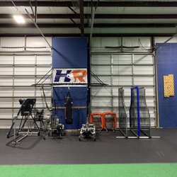 Hampton Roads Sports Academy - Machines, and other equipment are stored in the area off the side of the playing surface/batting cages.