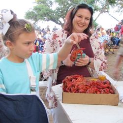 Llano Crawfish Open - Dancing in the back, one-handed crawfish eatin' in the front. Good luck, kid!  (Photo courtesy of LCO)