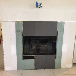 First he removed all the builder tile and then he added a metal schluter trim around the edges and inside which made it look really modern!