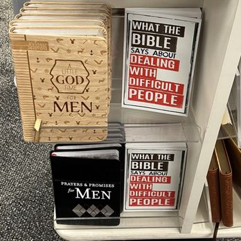 CVS Pharmacy - Books on the pharmacy line - The image shows a store shelf with religious and self-help books. On the left, there are multiple copies of a devotional book titled 'A Little God Time for Men' with a beige cover decorated with small symbols. To the right, there are two copies of a book titled 'What the Bible Says About Dealing with Difficult People,' with a white cover and bold black and red text. The shelf is part of a retail display, with a textured carpeted floor visible below. - Drugstores Near Me - Middletown, Rhode Island