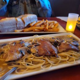 Veal Marsala, cheese steak sandwich in the back
