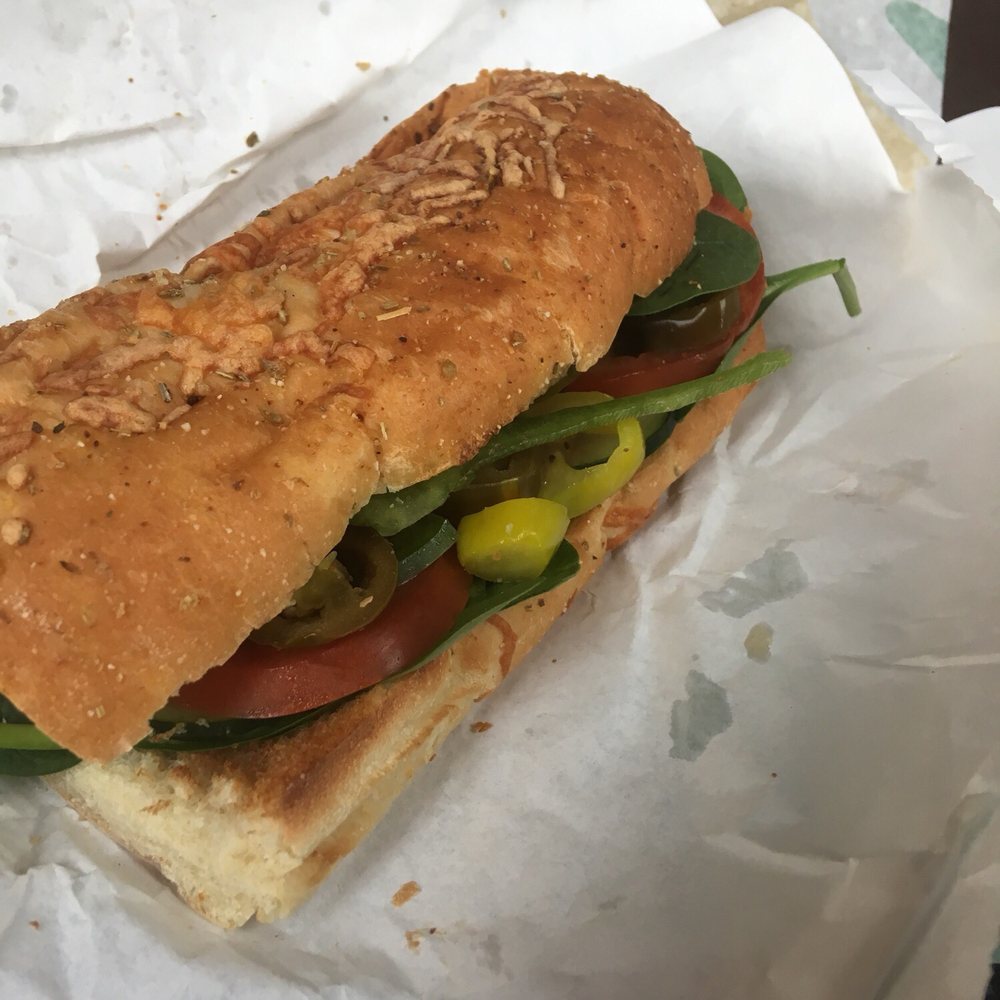 a sub sandwich on a piece of wax paper a sub sandwich on a piece of wax paper