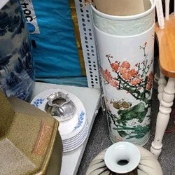 That tall vase, that is stored randomly on the floor, with brown waste paper it, was said to be $500