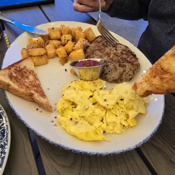 Tupelo Honey - Farmer's breakfast, potatoes fried w/parmesean & rosemary.  Toast was splattered with peach compote.  probably have the bacon next time. - American Near Me - Knoxville, Tennessee