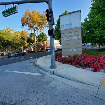 Walmart - Pylon Sign on California Street at Pachetti way. - Street corner with a traffic light, a signpost for California Street, and a directory listing stores like Walmart and Trader Joe's. - Department Stores Near Me - Mountain View, California