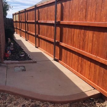 S&S Construction - a wooden fence with a concrete edging - Masonry/Concrete Near Me S&S Construction - a wooden fence with a concrete edging - Masonry/Concrete Near Me