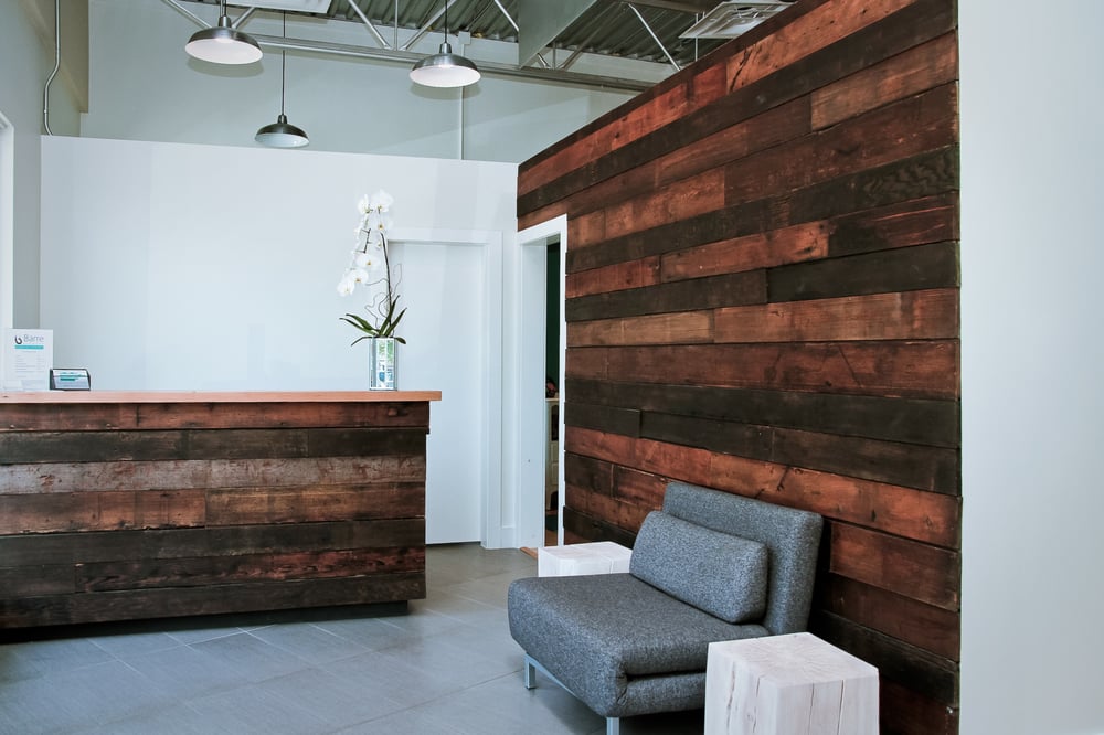 Welcoming Front Entrance Featuring A Reclaimed Wood Wall Welcoming Front Entrance Featuring A