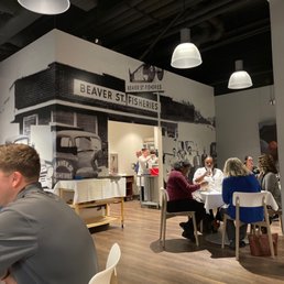 people sitting at tables in a restaurant