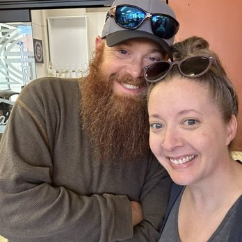 Cozy Corner - He surprised me and drove 35 mins to get that b&g and I'm not a morning person. - A man with a beard, wearing a cap and sunglasses, and a woman with sunglasses on her head are smiling in a casual setting. - Breakfast & Brunch Near Me - Brazil, Indiana