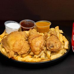Thang's Fish and Chicken - Juicy fried chicken legs and thighs with crispy fries, sauces, and Coke.