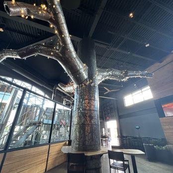 Dudleytown Brewing Company - The tree contributes to the overall dark, woodsy and mysterious vibe. It was created by welder Rhonda Dunlap. - Breweries Near Me - Windsor, Connecticut Dudleytown Brewing Company - The tree contributes to the overall dark, woodsy and mysterious vibe. It was created by welder Rhonda Dunlap. - Breweries Near Me - Windsor, Connecticut