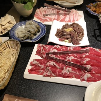 Happy Lamb Hot Pot - The table spread. Which includes, pork belly, garlic beef, tenderloin, shrimp, bok choy, mushroom, and a casing with fish eggs inside. - Mongolian Near Me - Edison, New Jersey Happy Lamb Hot Pot - The table spread. Which includes, pork belly, garlic beef, tenderloin, shrimp, bok choy, mushroom, and a casing with fish eggs inside. - Mongolian Near Me - Edison, New Jersey
