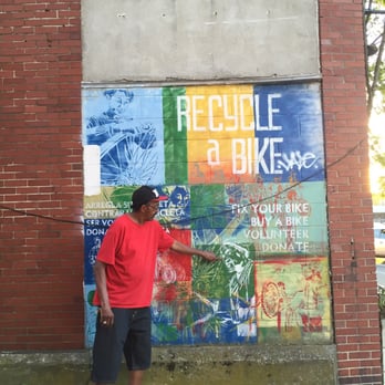 Recycle-A-Bike - Douglas showing me the mural (his face is on it). He's been fixing bikes since he was 8 years old. - Bike Repair/Maintenance Near Me - Providence, Rhode Island