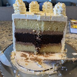 Three layer vanilla/chocolate gluten free cake with buttercream icing and metallic sprinkles (inside)