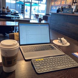 a laptop and a cup of coffee on a table