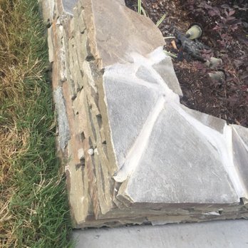 Y---------e Landscape - a close up of a stone wall - Landscaping Near Me