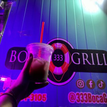 333 Boca grill - a hand holding a drink in front of a neon sign - Seafood Near Me - San Antonio, Texas 333 Boca grill - a hand holding a drink in front of a neon sign - Seafood Near Me - San Antonio, Texas