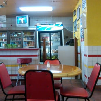 Los Catrachos Restaurant - a table and chairs - Latin American Near Me - Miami, Florida Los Catrachos Restaurant - a table and chairs - Latin American Near Me - Miami, Florida
