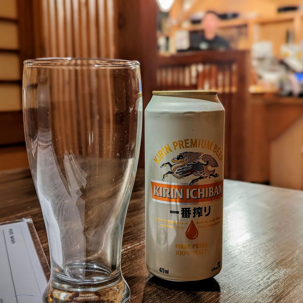 a beer and a glass on a table a beer and a glass on a table