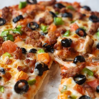 Village Pizza - a slice of pizza on a piece of parchment paper - Italian Near Me - Eagle Mountain, Utah Village Pizza - a slice of pizza on a piece of parchment paper - Italian Near Me - Eagle Mountain, Utah