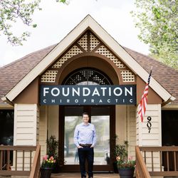 Dr. Pulver in front of our home-like office. We hope you feel at home here.