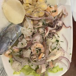 a plate of food with shrimp, potatoes, and lettuce a plate of food with shrimp, potatoes, and lettuce