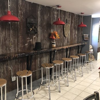 Lincoln Taproom - a row of stools in front of a bar - Beer Gardens Near Me - Pelzer, South Carolina