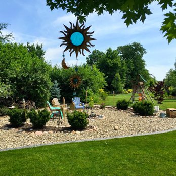 Dabah Landscape Designs - a garden with a lawn and a sun sculpture - Landscaping Near Me - Randolph, New Jersey