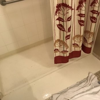 Courtyard by Marriott Springfield Downtown - Tub-less shower, possibly a ramp for a wheelchair...very slippery and dangerous when wet as well as allowing water to flow onto the floor. - Hotels Near Me - Springfield, Ohio