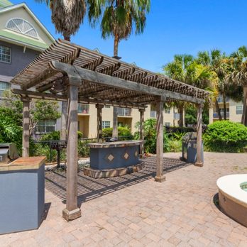 Coastline Apartments - A wooden pergola is over a hot tub in a courtyard - Apartments Near Me - Fort Walton Beach, Florida Coastline Apartments - A wooden pergola is over a hot tub in a courtyard - Apartments Near Me - Fort Walton Beach, Florida