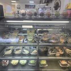 Cafe Bagel Barn - Assorted desserts, fruits, and muffins for purchase inside Cafe Bagel Barn