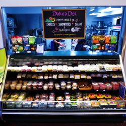 Moonflower Community Cooperative - Deli case featuring freshly made grab n' go sandwiches, salads, meals, and snacks