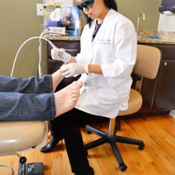 DM Foot & Ankle Associates - Dr. Kim performing laser treatment on fungal nails.