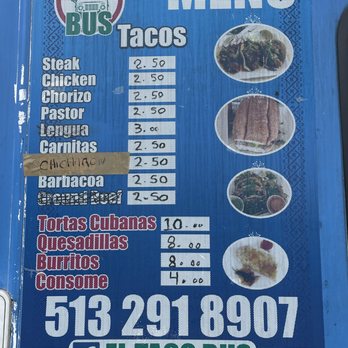 El Taco Bus - The current menu as of 3/23/22 - The image shows a blue menu board for Taco Bus, listing various food items such as tacos, tortas cubanas, quesadillas, burritos, and consomé, with prices ranging from $2.50 to $14.00. The menu includes images of tacos, a sandwich, and other dishes on the right side. The board also features the business's phone number and Facebook page, with a logo at the top left corner. The menu is printed on a textured blue background with decorative patterns. - Food Trucks Near Me - Cincinnati, Ohio