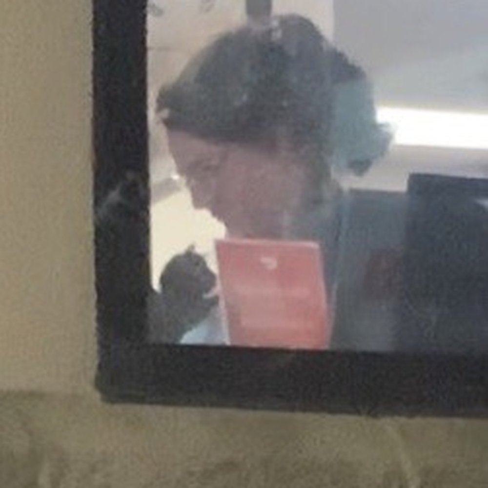 Sonic Drive-In - Employee holding a cat while working on orders .. - Burgers Near Me - Columbus, Ohio