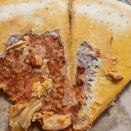 a half eaten pizza with meat and cheese a half eaten pizza with meat and cheese