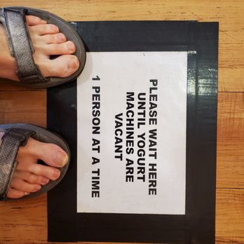 Tappy's Yogurt - a person standing on a floor with their feet on a sign - Ice Cream & Frozen Yogurt Near Me - Lewisville, Texas Tappy's Yogurt - a person standing on a floor with their feet on a sign - Ice Cream & Frozen Yogurt Near Me - Lewisville, Texas